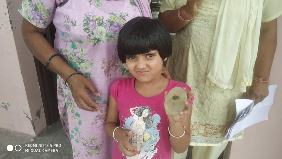 little girl showing herbal soap